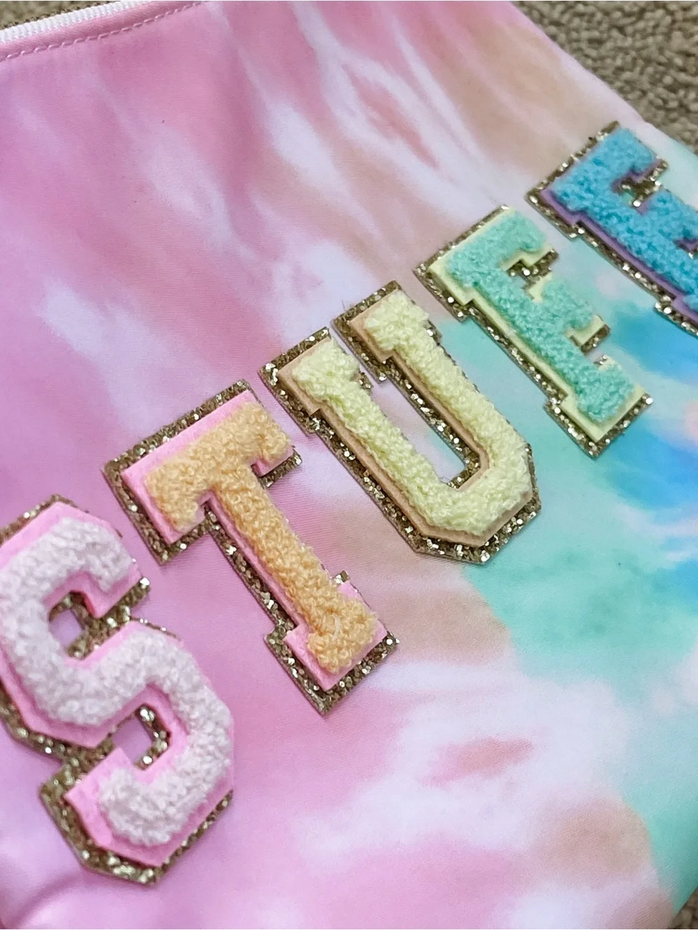 Stoney clover lane x target tie dye flat pouch with “STUFF” patches stuck on